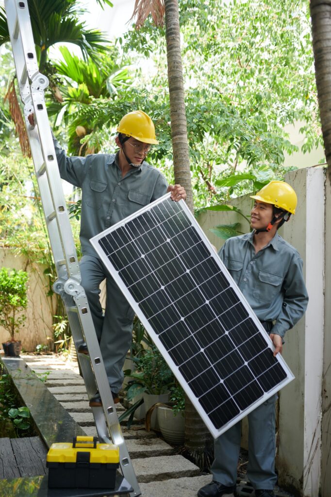 Coworkers Lifting Solar Panel